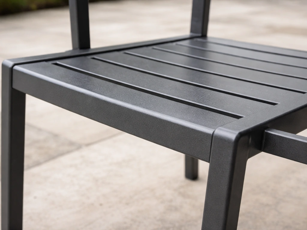Close-up of a cushion-free powder-coated aluminum chair seat slats showing the finish and frame details