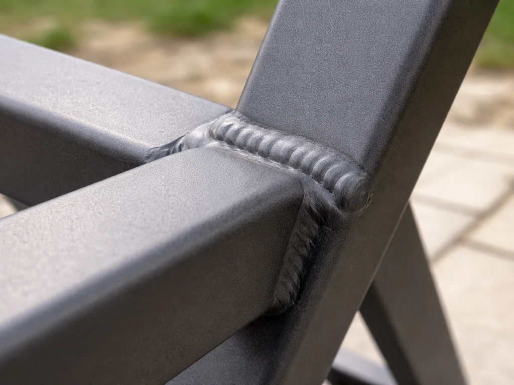 Close-up of a welded aluminum outdoor furniture hinge/joint and protective coating edge for inspection