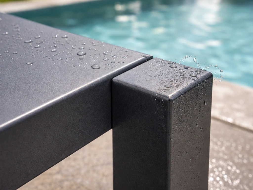 Close-up of powder-coated aluminum furniture surface and edges with water droplets near a pool splash zone.