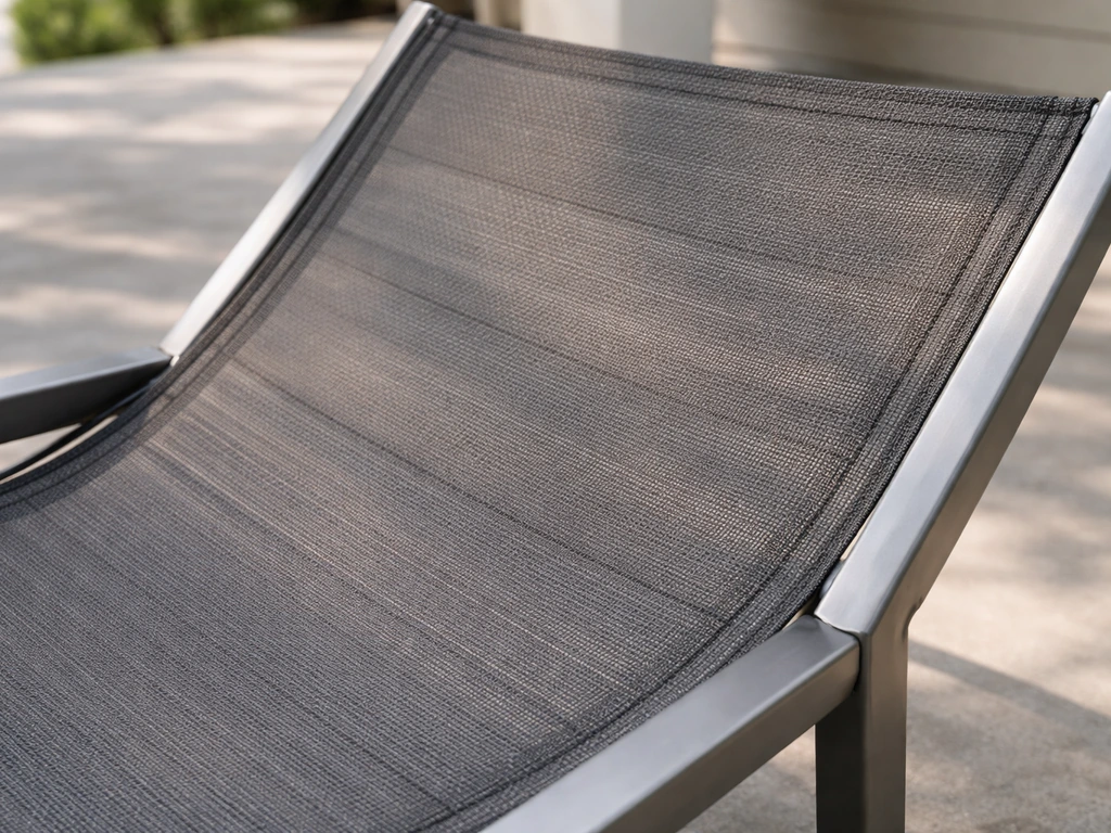 Close-up of a sling chair section with taut mesh fabric stretched between metal frame rails.