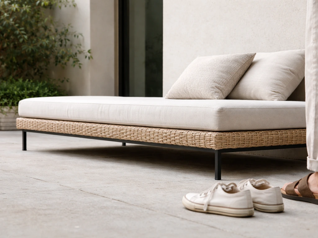 Side view of low patio seat close to the ground with standing ground level reference nearby.
