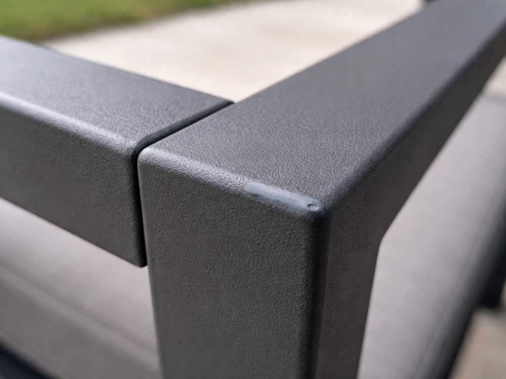Close-up of a matte powder-coated aluminum corner with crisp edges and a small touched-up chip