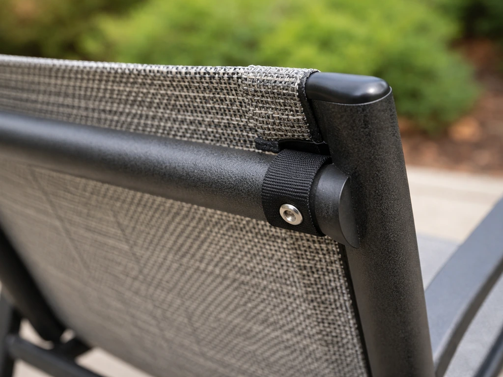 Close-up of tensioned mesh/sling seating attachment on an outdoor metal chair frame with visible hardware