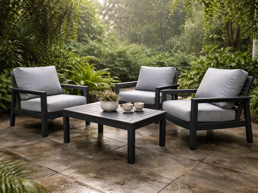 Clean aluminum and HDPE patio furniture on a damp-feeling patio with lush humid greenery.